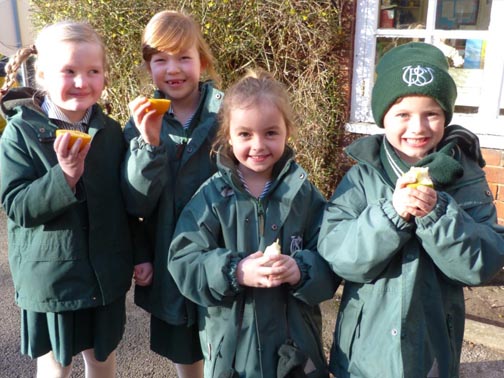 Pupils at Wilmslow Prep School eating fruit in the playground